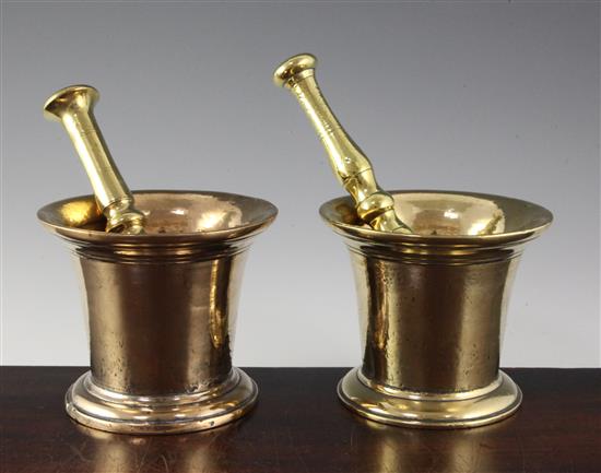 An 18th century bell metal mortar with brass pestle, 5.25in.